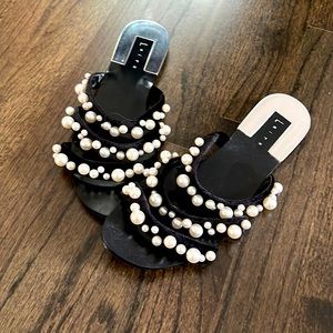 Black sandals with white pearls